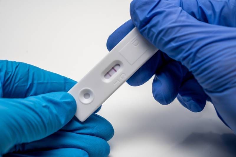 A person is holding an adult pregnancy test.