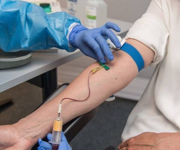 A person is getting an injection in his arm.